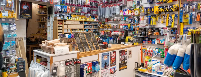 Inside Lyons Hardware: walls of tools and fixings behind the counter, with the engraved slate display in the middle