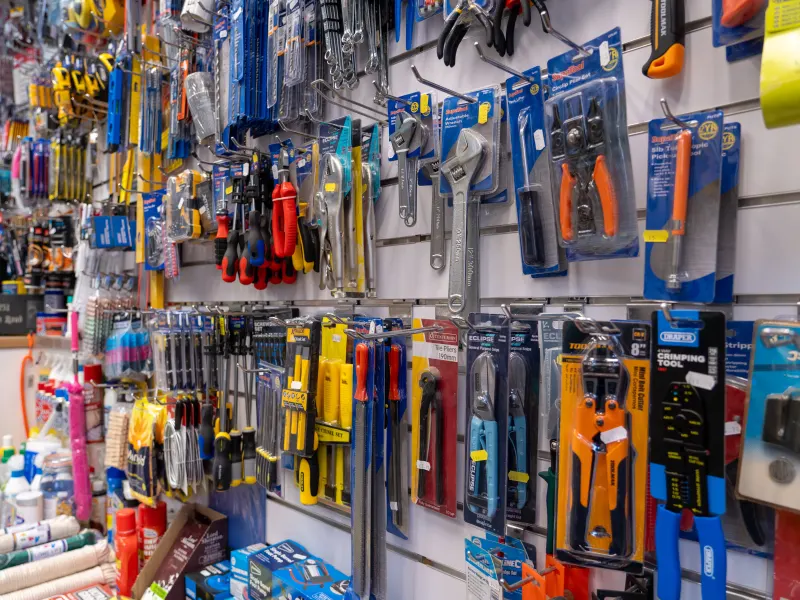 A wall of hand tools, pliers, spanners and cutters hanging on slatwall